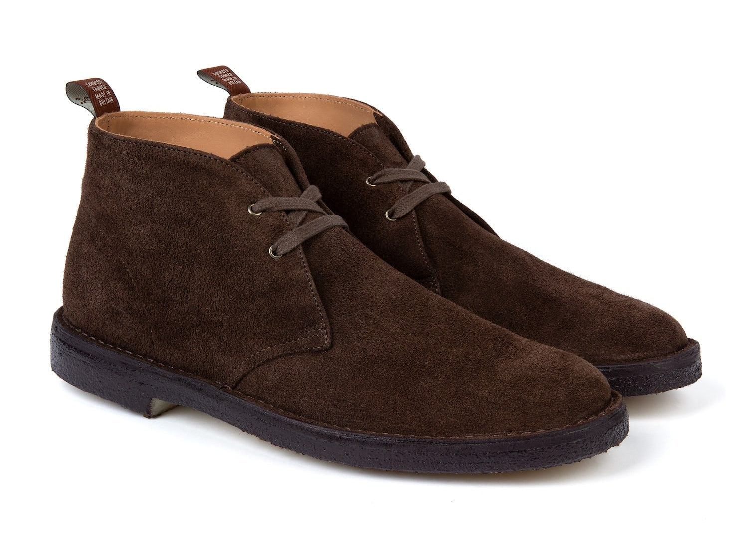A pair of brown suede desert boots with lace-up closure.
