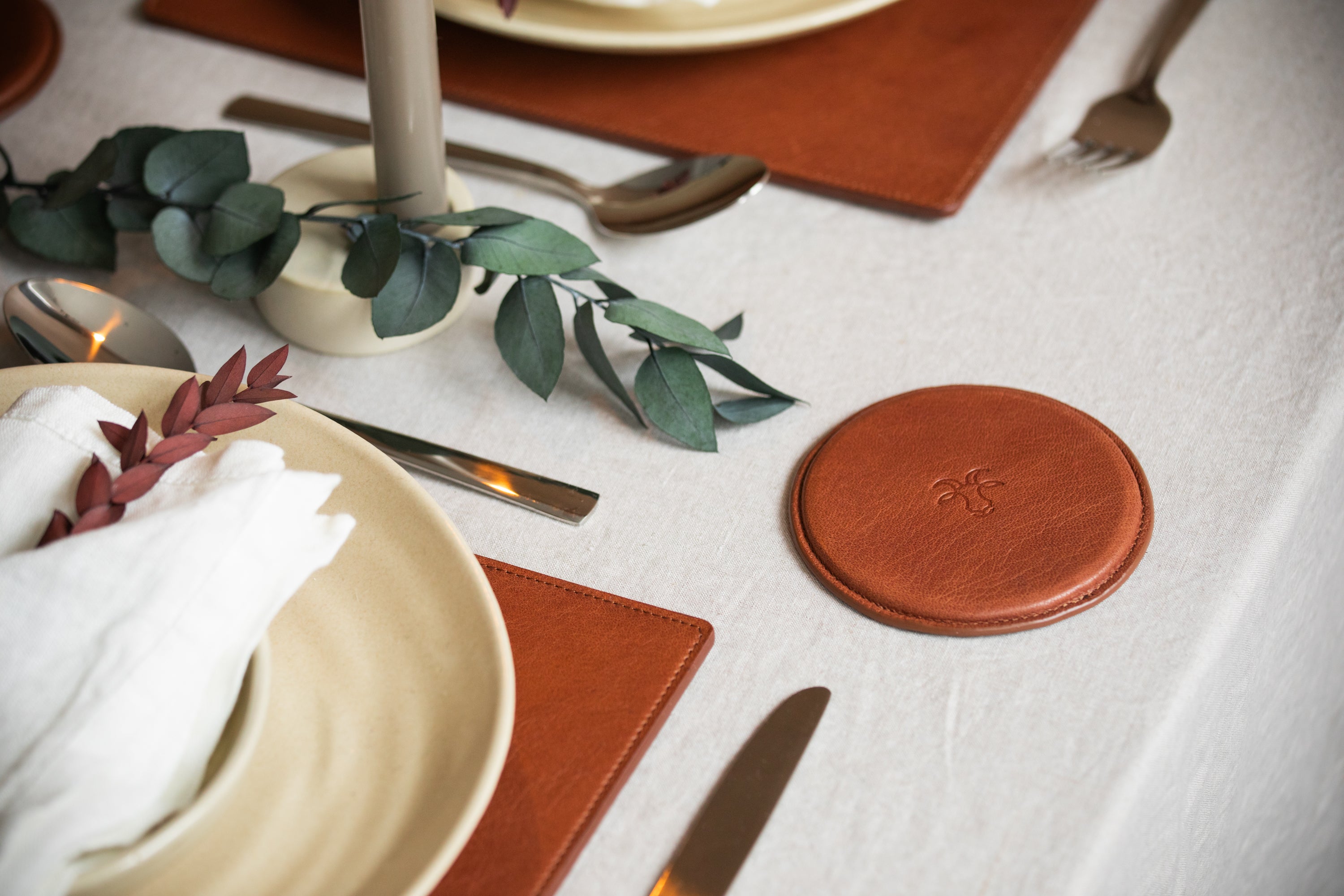 luxury Christmas table setting with leather placemats and coasters